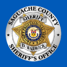 Blue Background with Sheriff Badge that says Saguache County Sheriff's Office D. Warwick